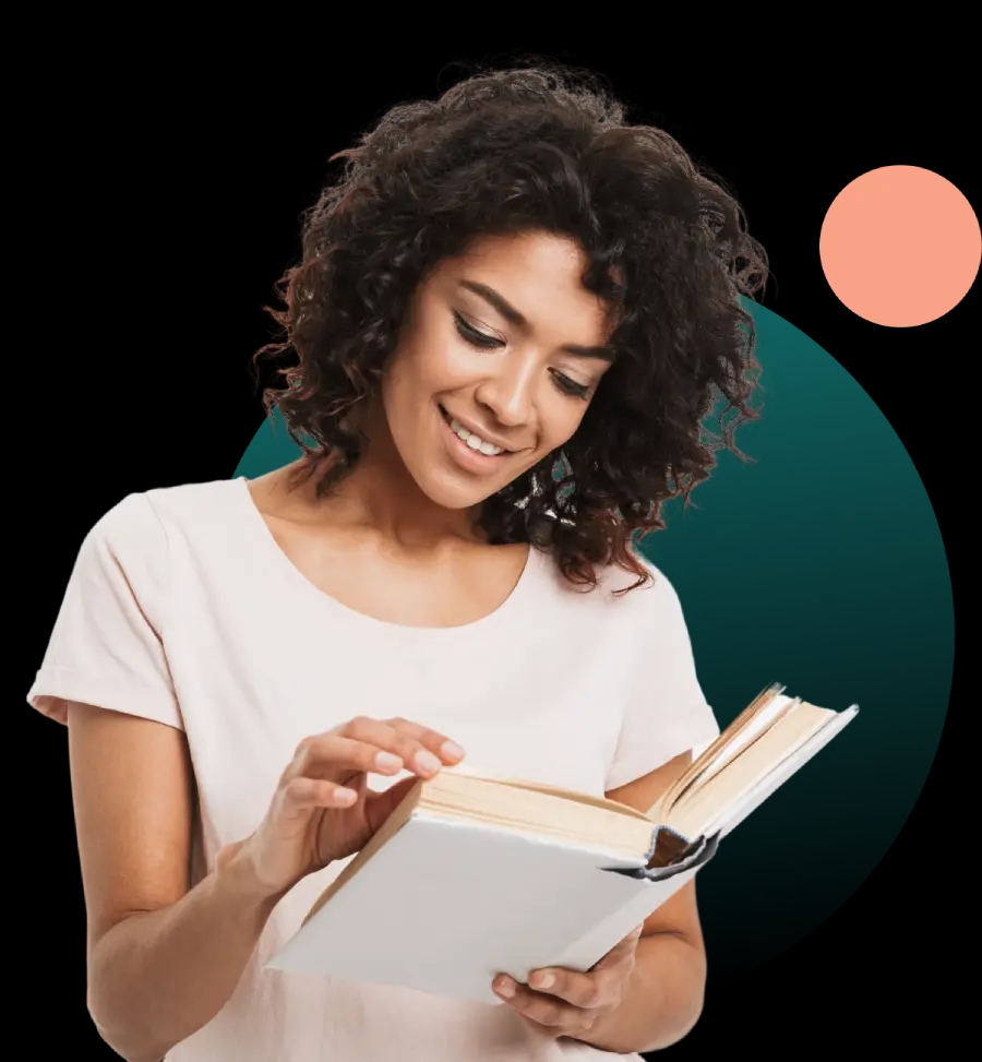 Young woman smiling and reading a book